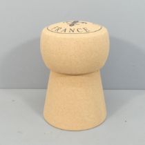 A contemporary champaign cork design stool. 34x51cm.