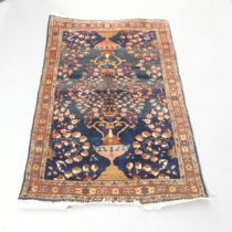 A blue ground Caucasian rug. 147x101cm. Faded and worn, some loss to fringes. Appears to have been