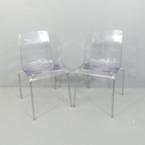 A pair of contemporary Italian perspex dining chairs on chrome frames.