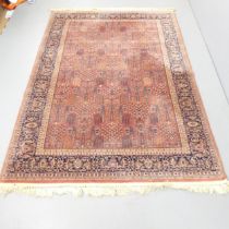 A red-ground Persian machine made rug. 242x160cm.