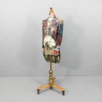 A decoupage decorated mannequin on wooden stand. Height 157cm.