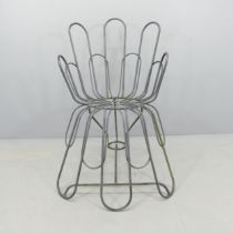 A modernist tubular metal chair. Overall 69x98x90cm, seat 34x48x34cm.