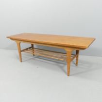 A mid-century teak two-tier coffee table. 122x40x39cm.