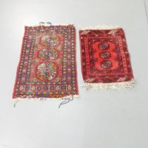 Two red-ground Afghan mats. Largest 90x62cm. (2) Largest has areas of wear and pile loss.