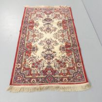 A machine made oriental design rug. 157x93cm. Some signs of use, including moth damage.