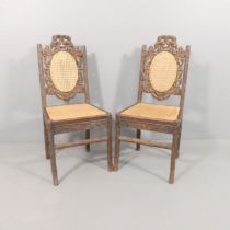 A pair of Black Forest naturalistically carved side chairs, the seats and backs recently re-caned.