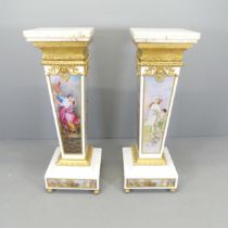 A pair of composite continental style marble-topped plinths, with brass mounts and printed classical