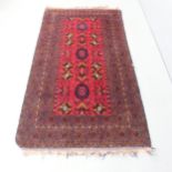 A red-ground Hamadan rug. 196x111cm. Some wear to edges.