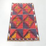 A red-ground Baluchi rug. 137x84cm.
