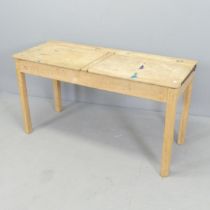 A vintage pine double school desk, with lifting lids. 103x60x46cm. Good condition, with the usual