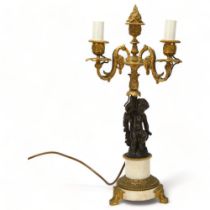 19th century parcel-gilt bronze twin-branch lamp, supported by a putto figure, on bronze-mounted