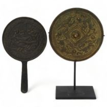 A Chinese relief cast patinated bronze mirror, with gilded dragon decoration, diameter 12cm, and a