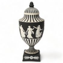 Wedgwood black and white Jasper urn and cover, decorated with dancing maidens, height 25cm All in