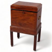 George III mahogany cellarette, the inlaid top having a concave edge, brass carrying handles and