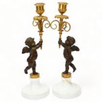 Pair of 19th century parcel-gilt bronze candlesticks, supported by cherubs on white ceramic bases,