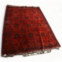 A Large Afghan red ground Balouch rug 290 x 204cm