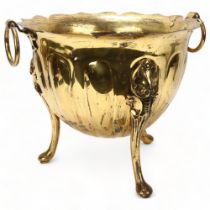 A 19th century brass jardiniere, with ring handles on 3 cast feet, height 30cm, diameter 35cm