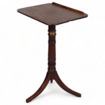 A George III mahogany reading table, with rise and fall tilt top, brass adjusting mechanism and