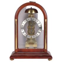 A modern Hermle mahogany-cased dome-top mantel clock with brass columns, movement striking on a