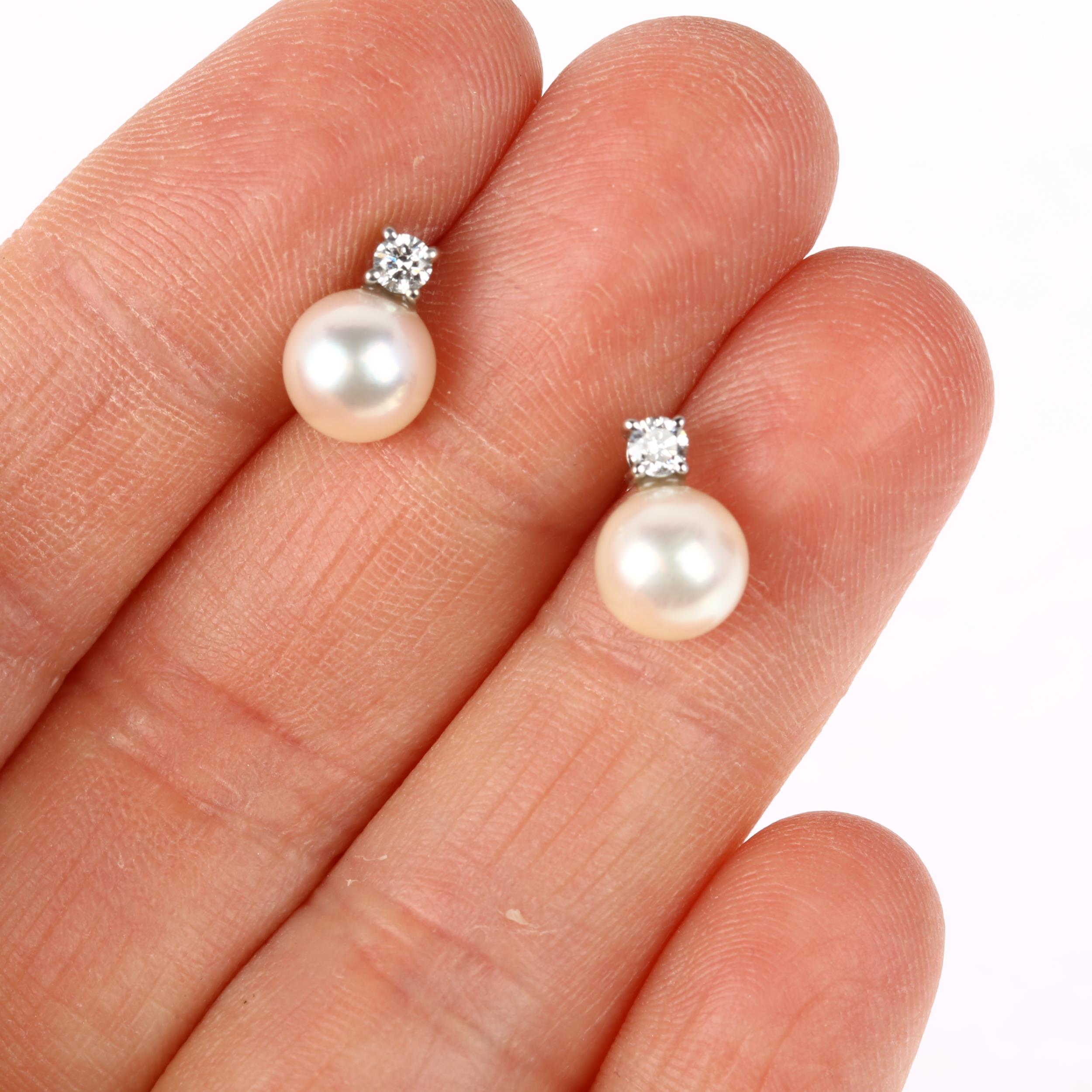 A pair of 18ct white gold whole pearl and diamond earrings, each claw set with 0.07ct modern round - Image 4 of 4