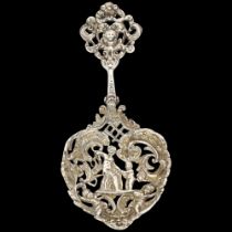 A Victorian silver decorative serving/sifter spoon, William Comyns, London 1891, relief chased and