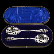 A pair of George V silver strawberry spoons, Martin Hall & Co, Sheffield 1910, pierced foliate
