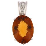 An 18ct white gold citrine and diamond drop pendant, set with oval rose-cut citrine and modern round