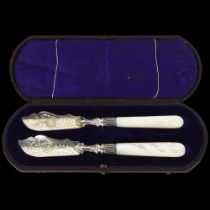 A pair of Victorian silver mother-of-pearl handled butter knives, Harrison Brothers & Howson,