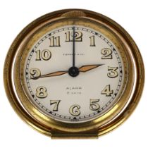 TIFFANY & CO - an Art Deco gilt-brass 8-day travelling alarm clock, by Cortland Concord Watch Co,