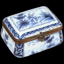 Delft blue and white pottery box of bulbous rectangular form, hinged metal rim with ogee sides, 7.