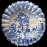 Delft blue and white pottery charger, of lobed circular form, diameter 35cm A number of tiny glaze