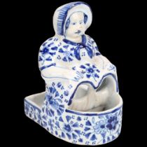 Dutch Delft blue and white pottery figural pot, height 13cm Tiny glaze chips on the edge of her