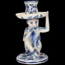 Delft blue and white pottery candlestick, supported by a monkey, height 18cm Very light glaze