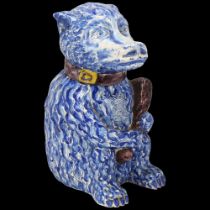 Portuguese blue and white faience figural bear container with club, height 25cm Lid has 2 short