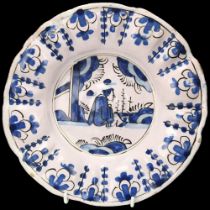 Delft blue and white pottery dish of lobed circular form, diameter 25cm Minor glaze chips on the rim