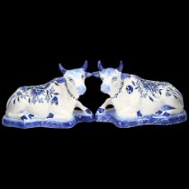 Pair of Dutch Delft blue and white pottery recumbent cow figures, length 16cm Minor glaze rubbing on