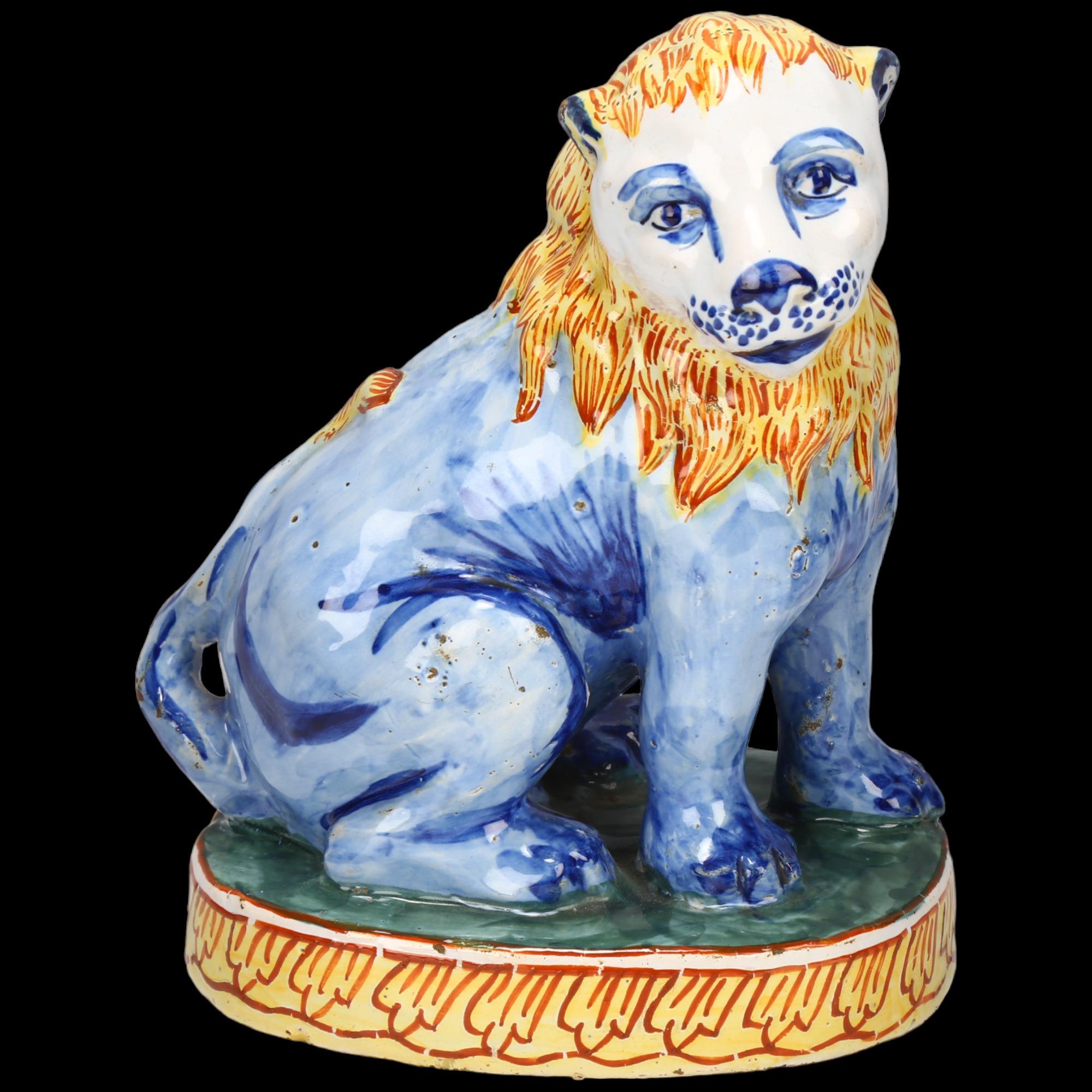 Dutch Delft polychrome pottery lion, height 17cm Small area of glaze rubbing on the tail, tiny glaze