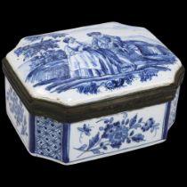 Dutch Delft blue and white pottery box of canted rectangular form, the domed lid decorated with