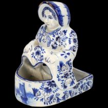 Dutch Delft blue and white pottery figural pot, height 13cm Tiny glaze chips on the edge of her