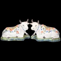 Pair of Delft polychrome faience pottery recumbent cows, base length 17cm Good condition, minor