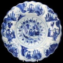 Delft blue and white pottery dish of lobed circular form, diameter 34cm Hairline crack visible on