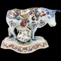 Dutch Delft polychrome pottery cow and milkmaid, base length 20cm Base has had some professional