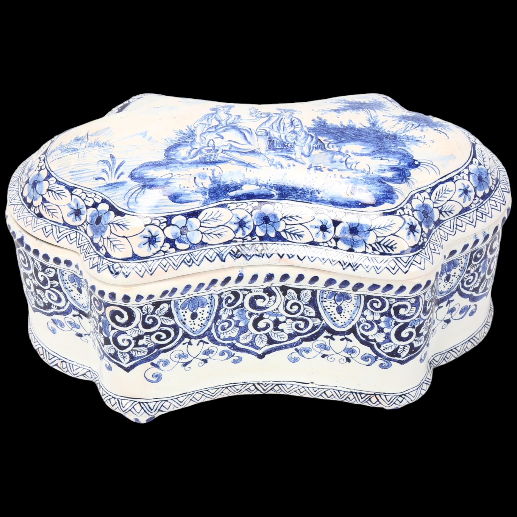 Delft blue and white pottery box and cover of shaped oval form, length 19cm, height 10cm Very