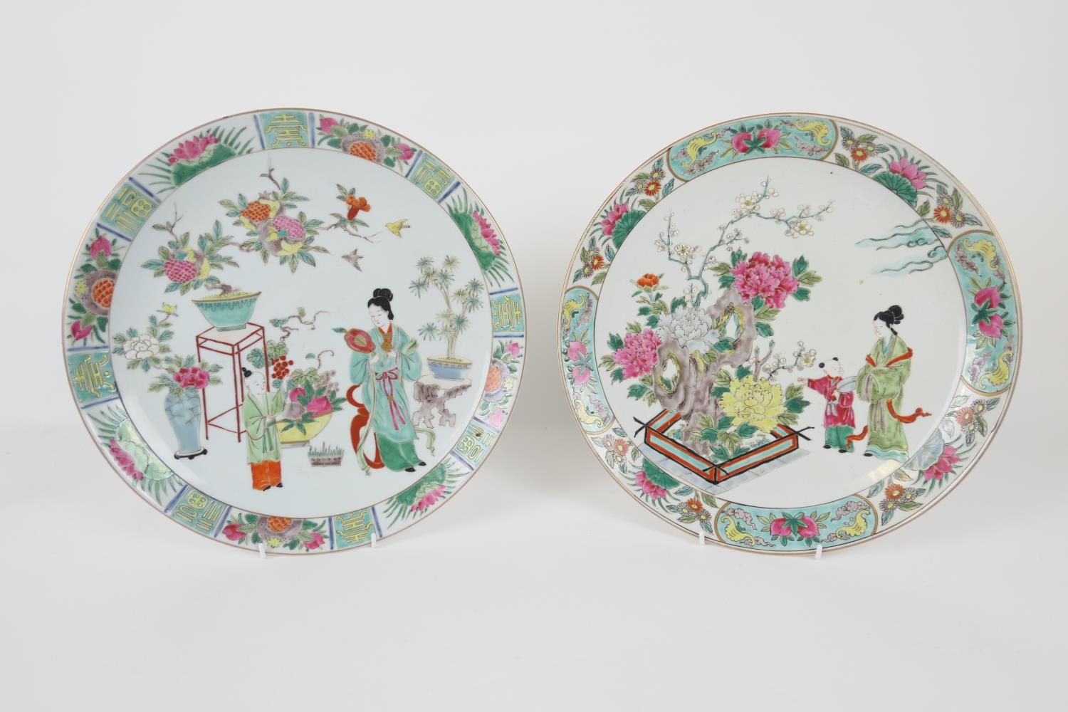Two Japanese porcelain plaques, decorated in Chinese famille rose style, 34cm diameter