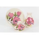 Three Moorcroft magnolia pattern pieces comprising a white ground baluster vase, 19cm, a squat