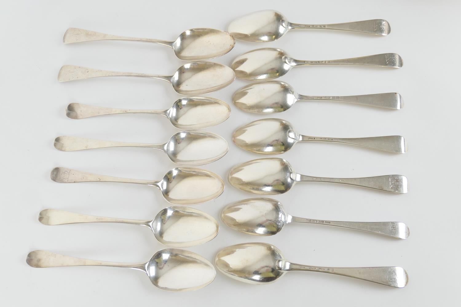 Twelve George III silver Hanoverian pattern table spoons, low marks, various makers, all London,