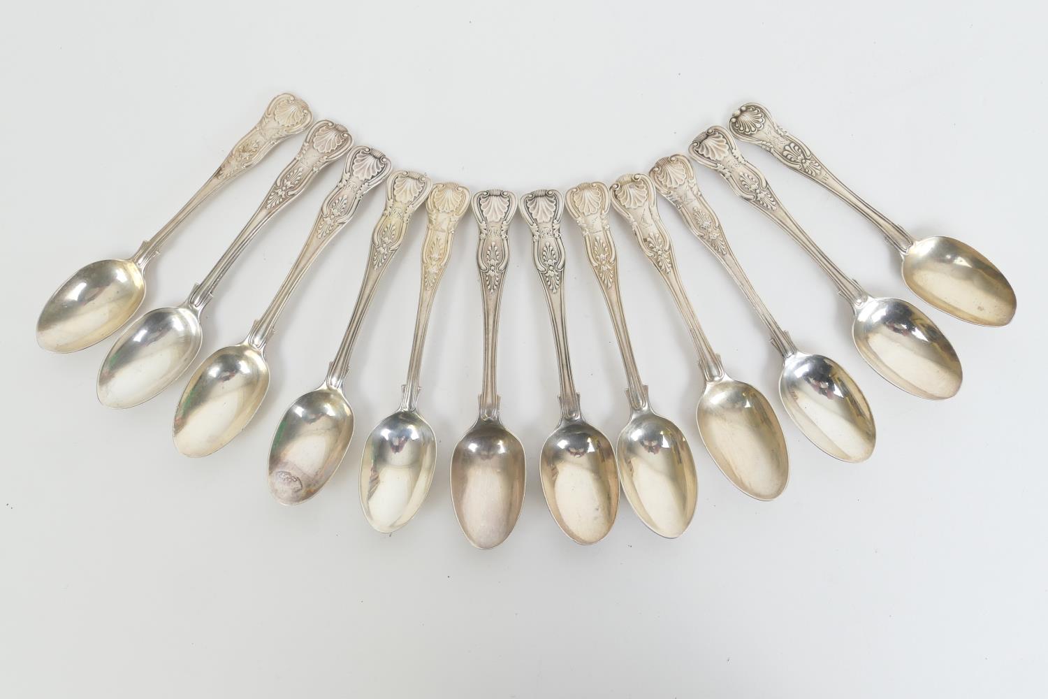 Twelve Victorian and later silver Queens pattern teaspoons, engraved with a monogram and an arm