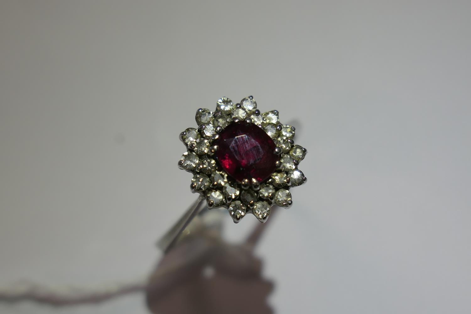 Ruby and diamond cluster ring, the oval cut ruby of approx. 1ct, bordered with small round cut - Image 6 of 9