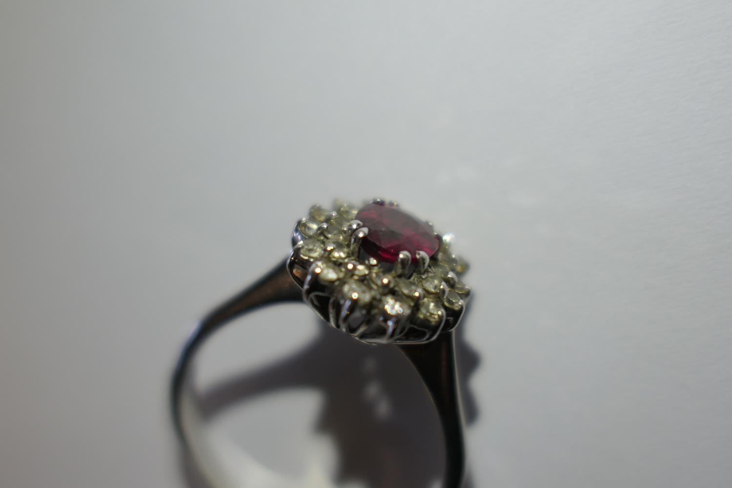 Ruby and diamond cluster ring, the oval cut ruby of approx. 1ct, bordered with small round cut - Image 4 of 9