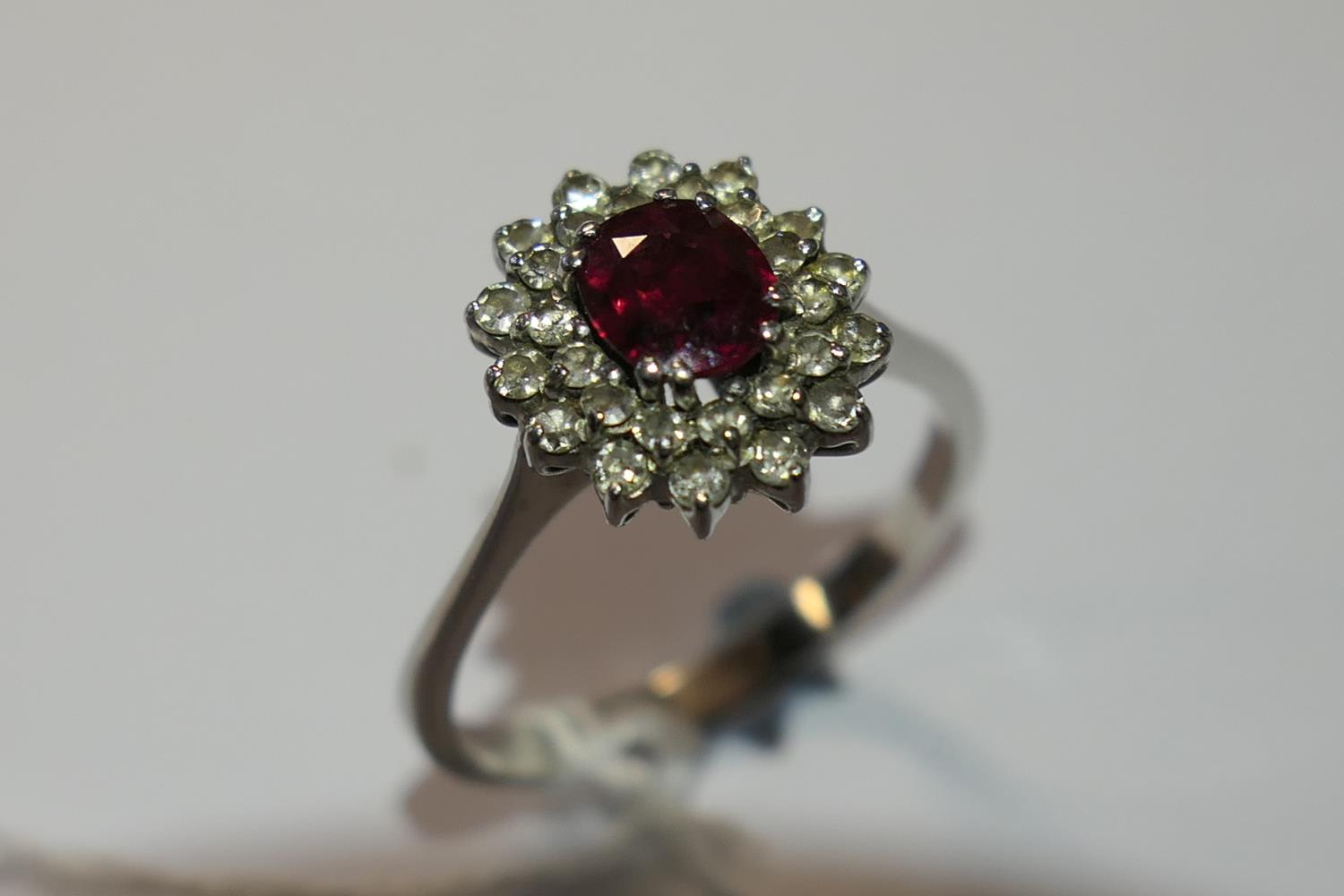 Ruby and diamond cluster ring, the oval cut ruby of approx. 1ct, bordered with small round cut - Image 7 of 9